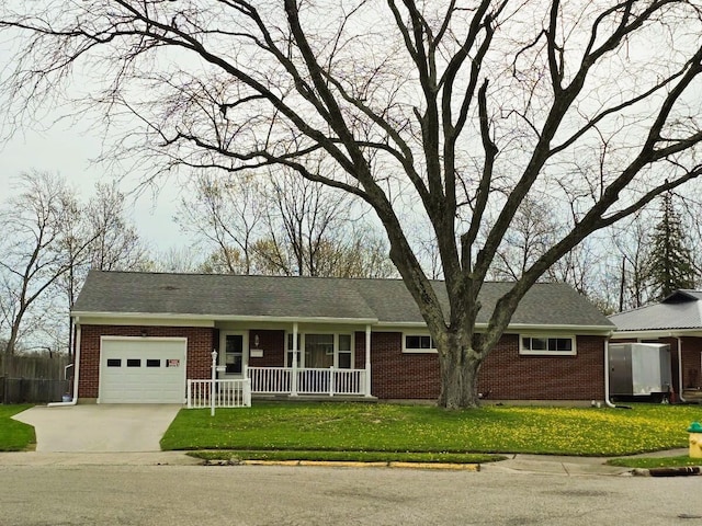 1506 Torrence Dr, Springfield, OH 45503 - ranch-style home featuring brick siding, an attached garage, concrete driveway, and covered porch