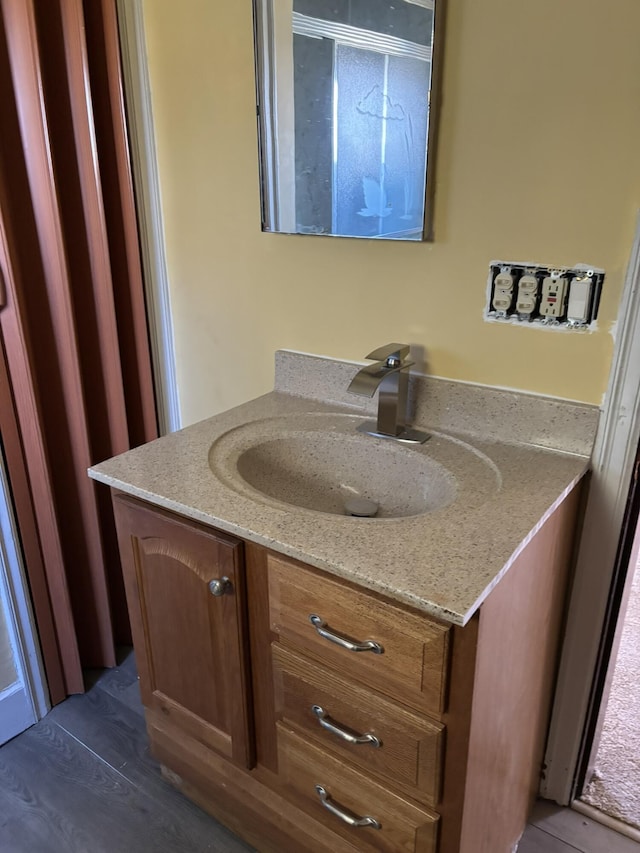 bathroom featuring wood finished floors and vanity