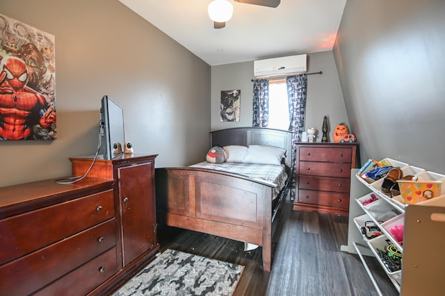 bedroom with a wall unit AC, a ceiling fan, and dark wood-type flooring