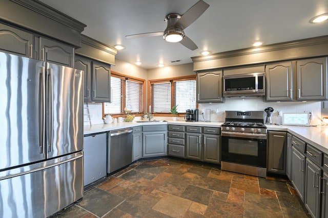 kitchen with appliances with stainless steel finishes, gray cabinets, visible vents, and tasteful backsplash