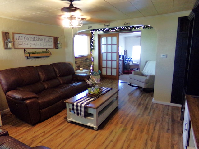 88 E Clark St, North Hampton, OH 45349 - living area with ornamental molding, light wood finished floors, a ceiling fan, arched walkways, and baseboards