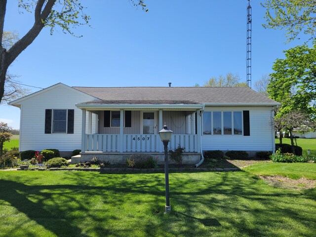 ranch-style house featuring a porch and a front yard