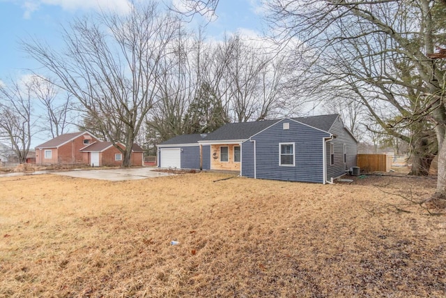 ranch-style house with a front lawn and central air condition unit