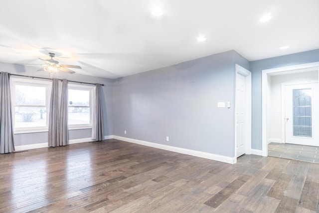 unfurnished room featuring dark wood-type flooring and ceiling fan