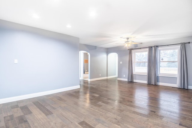 empty room with dark hardwood / wood-style flooring and ceiling fan