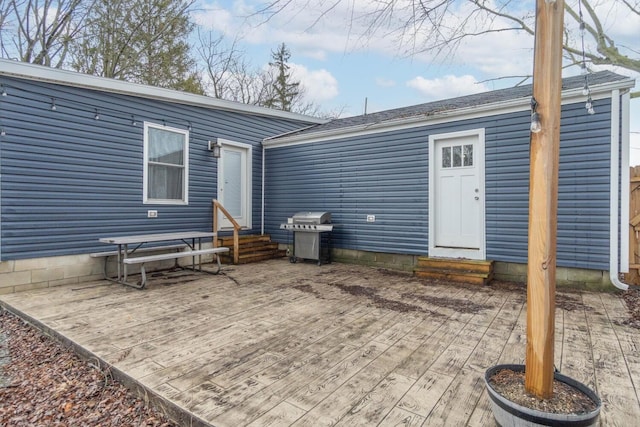 rear view of house featuring a wooden deck