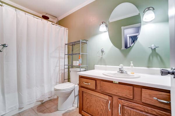 bathroom featuring crown molding, tile patterned floors, toilet, and vanity