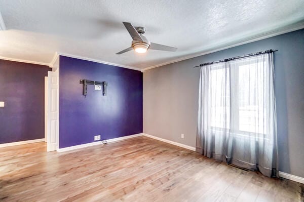 spare room featuring hardwood / wood-style flooring, crown molding, a textured ceiling, and ceiling fan