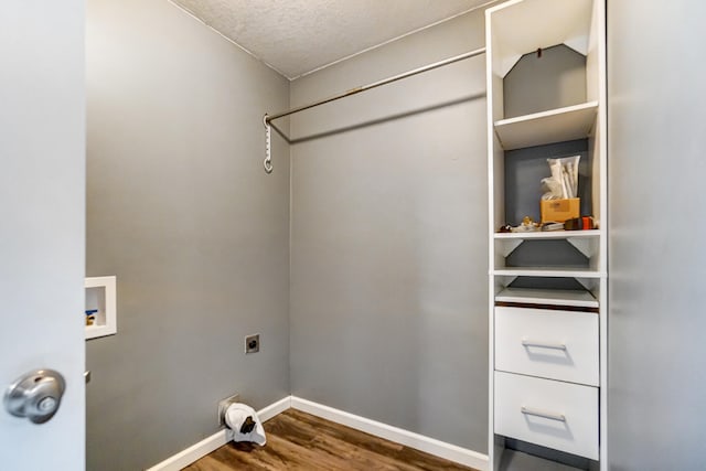 washroom with washer hookup, dark hardwood / wood-style floors, a textured ceiling, and electric dryer hookup