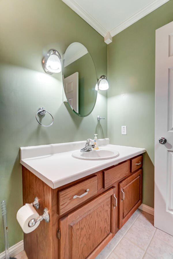 bathroom featuring vanity, crown molding, and tile patterned floors