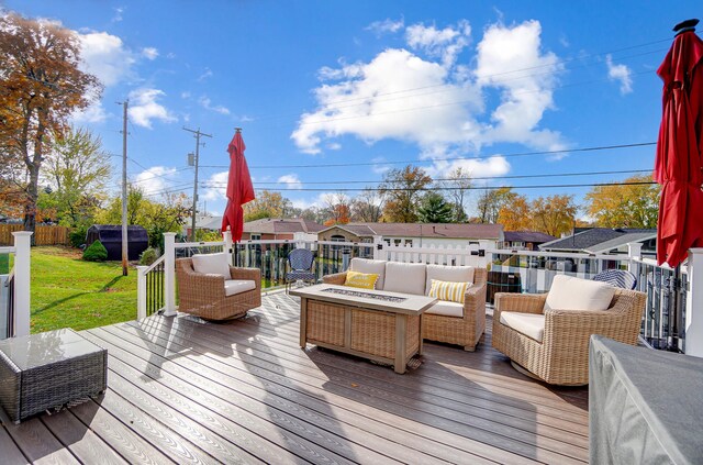 wooden deck with an outdoor living space with a fire pit, a shed, and a lawn