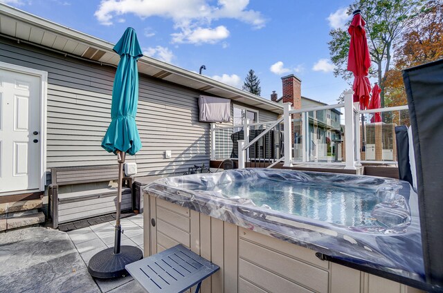 wooden deck featuring a hot tub