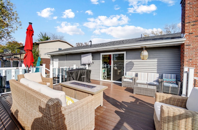 wooden deck with an outdoor living space with a fire pit