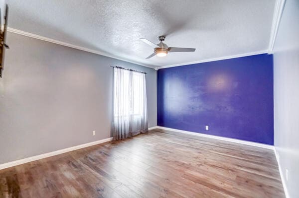 unfurnished room featuring crown molding, a textured ceiling, ceiling fan, and hardwood / wood-style flooring