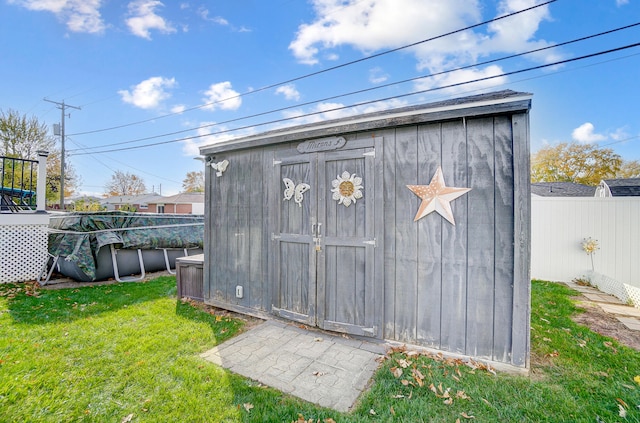 view of outbuilding featuring a yard