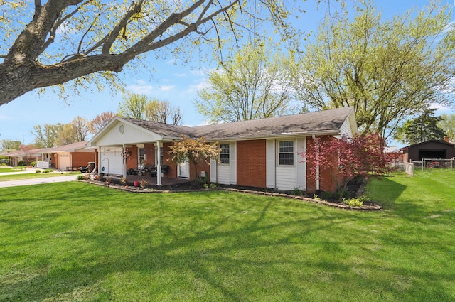 single story home with a garage, concrete driveway, fence, a front yard, and brick siding