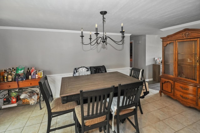 dining area with a chandelier, light tile patterned floors, and crown molding