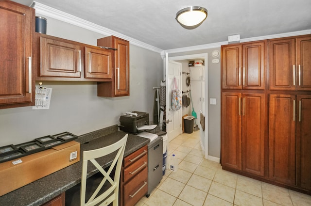 kitchen with dark countertops, crown molding, and light tile patterned floors