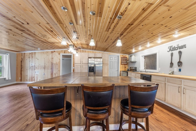 kitchen with stainless steel fridge, black dishwasher, tile counters, and wooden ceiling