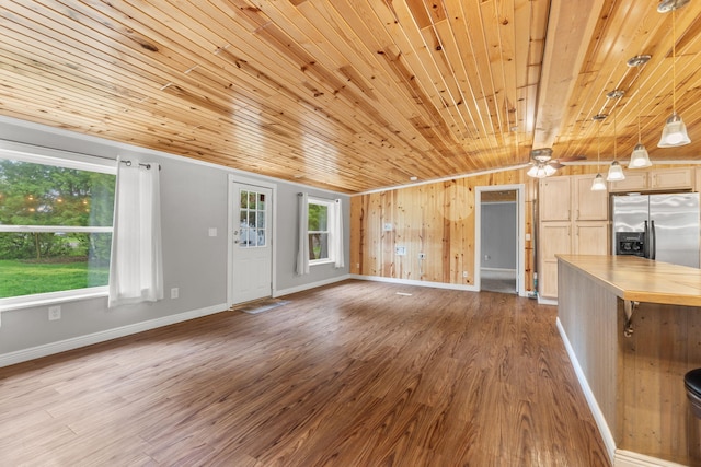 unfurnished living room featuring wood ceiling, baseboards, wood walls, and dark wood-style flooring