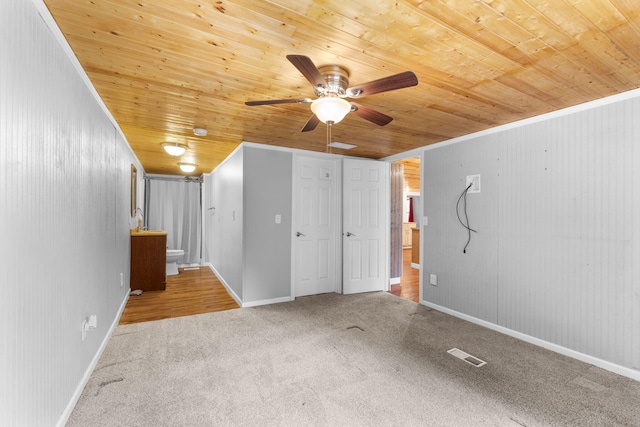 interior space featuring carpet flooring, ceiling fan, visible vents, and wood ceiling