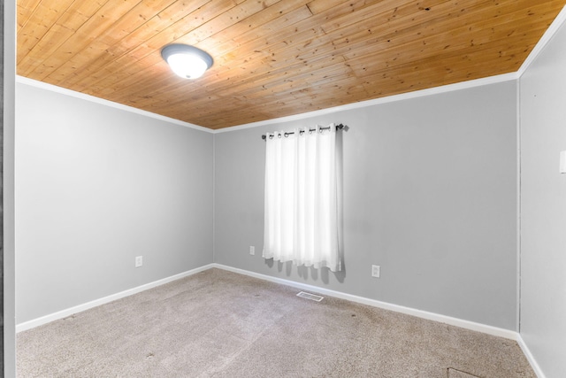 unfurnished room with visible vents, crown molding, carpet floors, and wooden ceiling