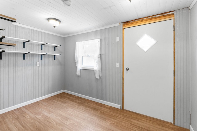 foyer entrance with light wood-style floors, wood ceiling, and crown molding