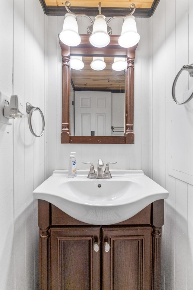 bathroom with vanity and a decorative wall