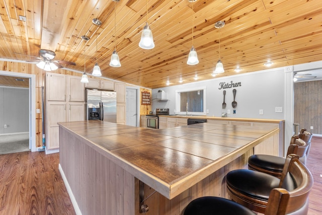 kitchen featuring dark wood-style flooring, appliances with stainless steel finishes, tile counters, wooden ceiling, and vaulted ceiling