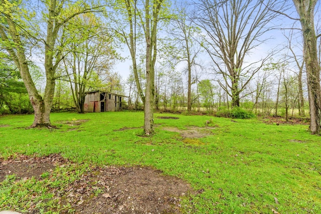 view of yard featuring a barn and an outbuilding