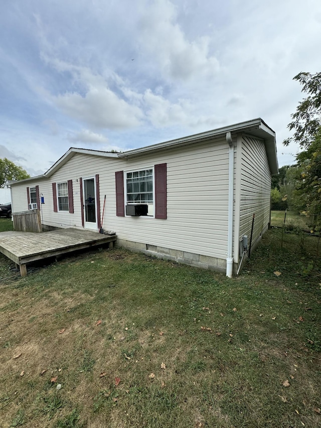 back of house featuring a yard and a deck