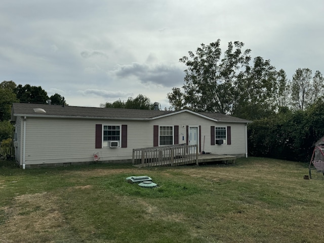 view of front facade featuring cooling unit, a wooden deck, and a front yard