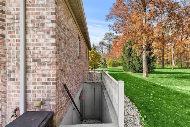 view of side of property with a lawn and brick siding