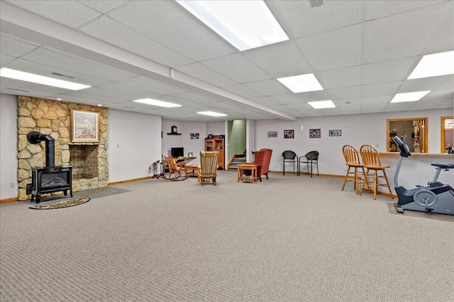 interior space featuring a wood stove, carpet, and baseboards