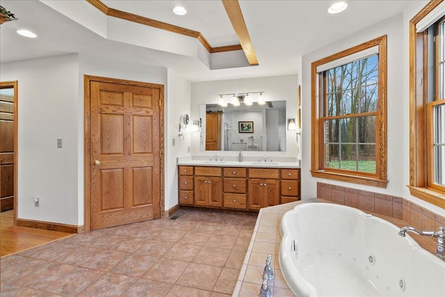 bathroom featuring a whirlpool tub, double vanity, a sink, and baseboards