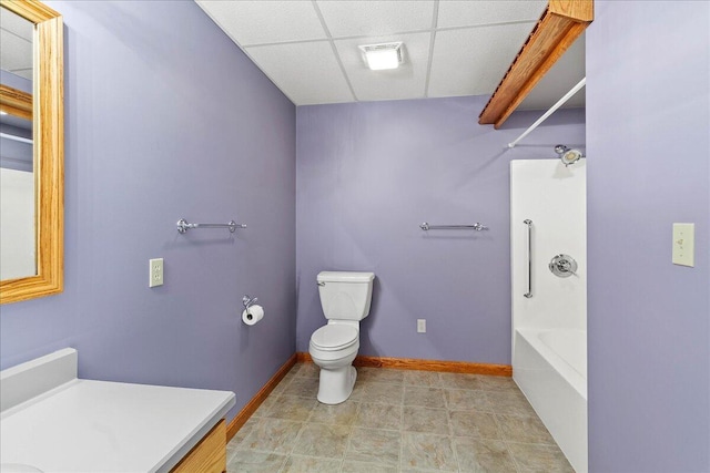 bathroom featuring a paneled ceiling, baseboards, vanity, and toilet