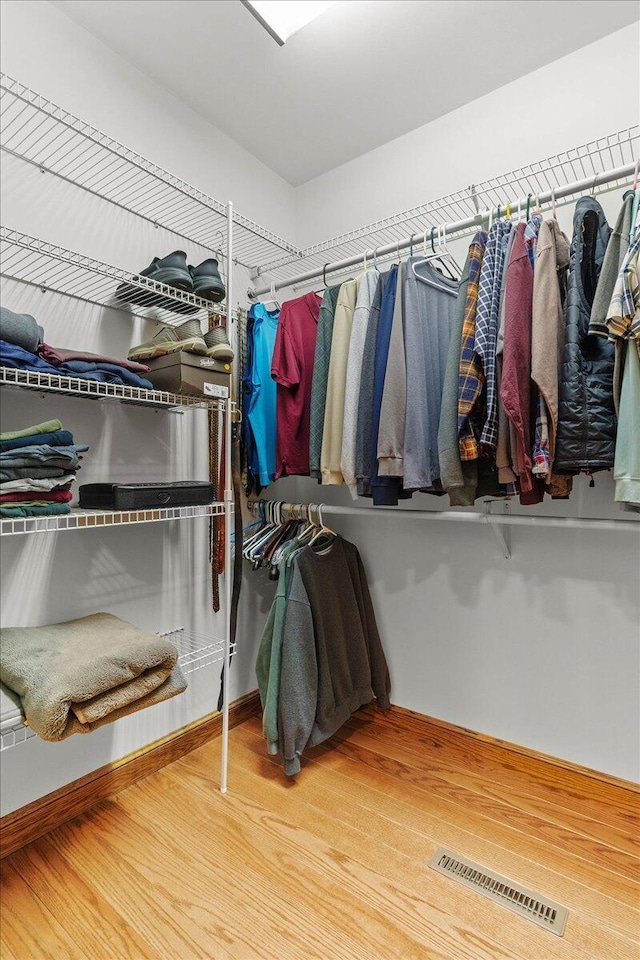 spacious closet with wood finished floors and visible vents