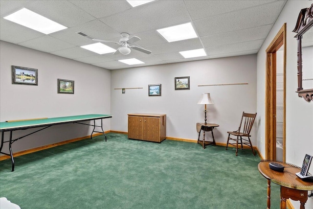 rec room with carpet, visible vents, ceiling fan, a drop ceiling, and baseboards