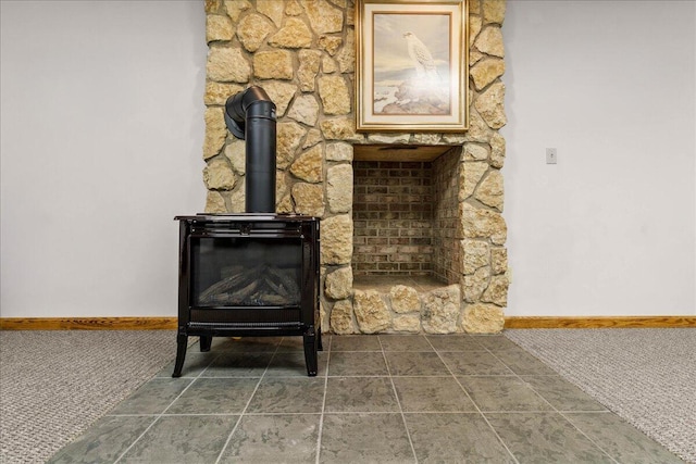 details with carpet floors, a wood stove, and baseboards