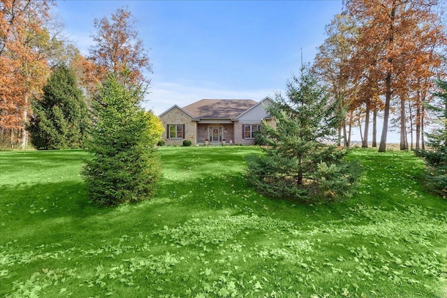 view of front of house featuring a front yard and brick siding