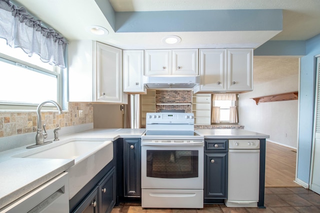 kitchen with white cabinetry, sink, white appliances, and decorative backsplash