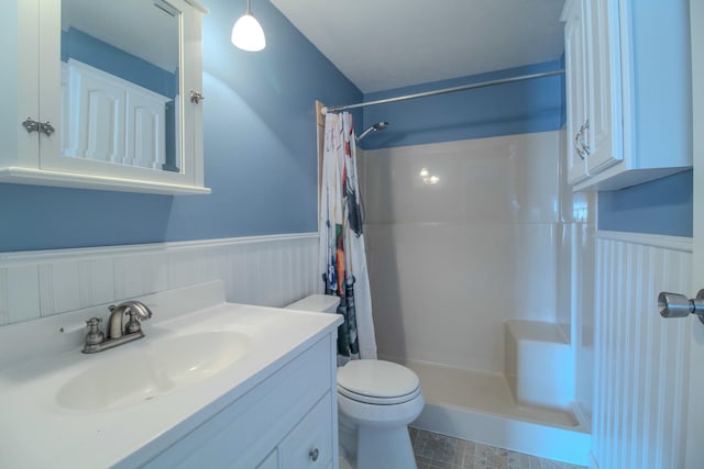 bathroom featuring vanity, toilet, and walk in shower