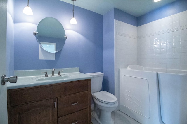 bathroom with vanity, a bath, and toilet