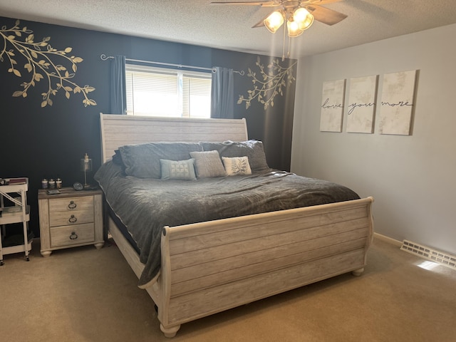 bedroom featuring ceiling fan, a textured ceiling, and dark colored carpet