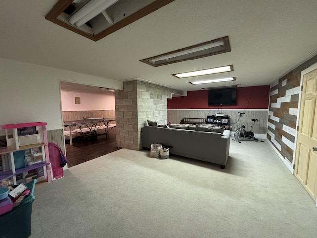 carpeted office featuring wooden walls