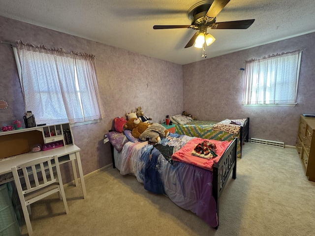 bedroom with ceiling fan, light colored carpet, a baseboard radiator, and a textured ceiling