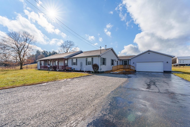 single story home with a garage, a front yard, and covered porch