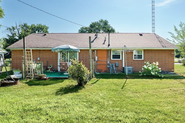 413 Weinland St, New Carlisle, OH 45344 - rear view of house featuring brick siding, a yard, and roof with shingles