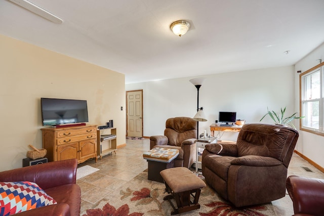 413 Weinland St, New Carlisle, OH 45344 - living room featuring baseboards and stone finish flooring