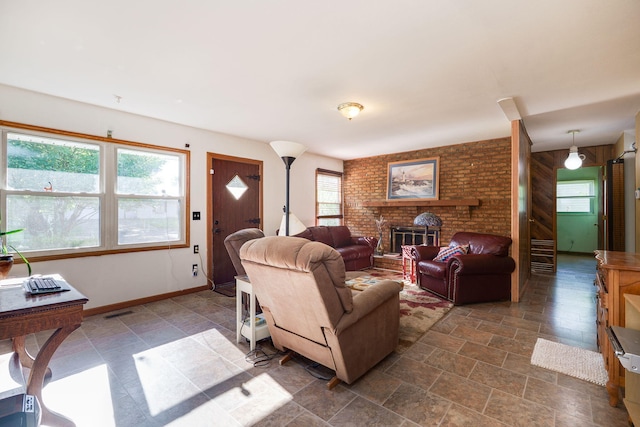 413 Weinland St, New Carlisle, OH 45344 - living room featuring a brick fireplace and dark stone finish floors